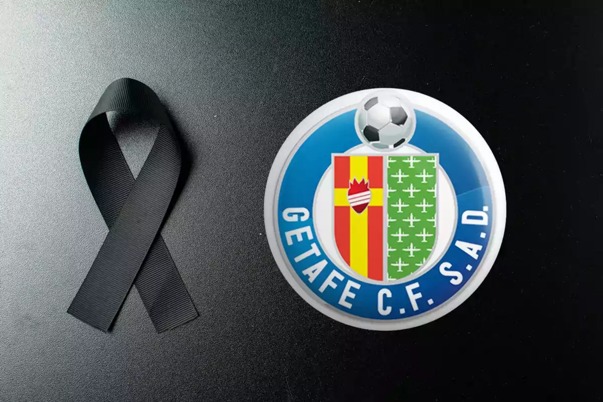 Lazo negro junto al escudo del Getafe C.F. sobre fondo oscuro.