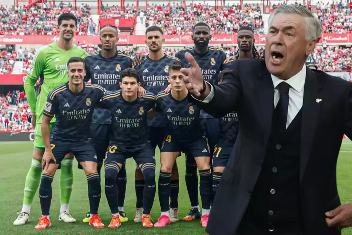 Un equipo de fútbol posando para una foto grupal en el campo, con su entrenador gesticulando en primer plano.