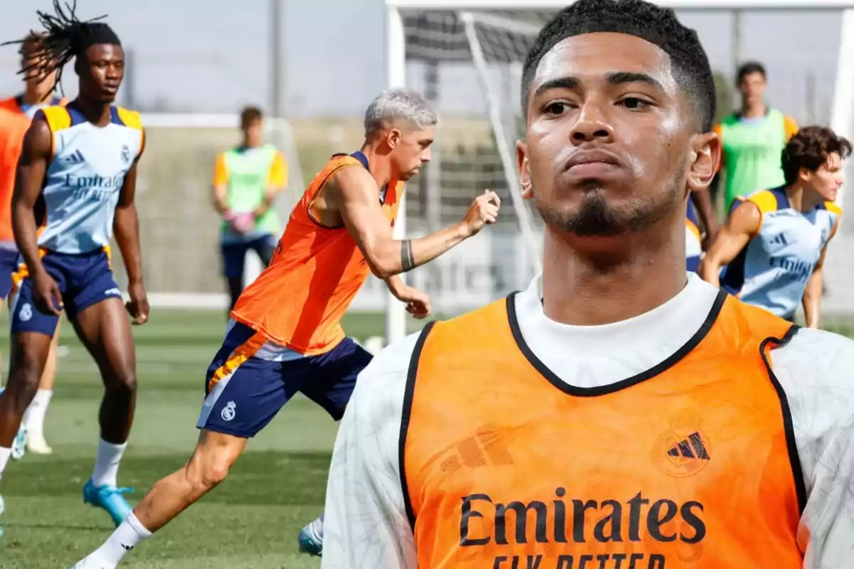 Jugadores de fútbol entrenando en un campo con petos naranjas y uniformes de entrenamiento del Real Madrid.