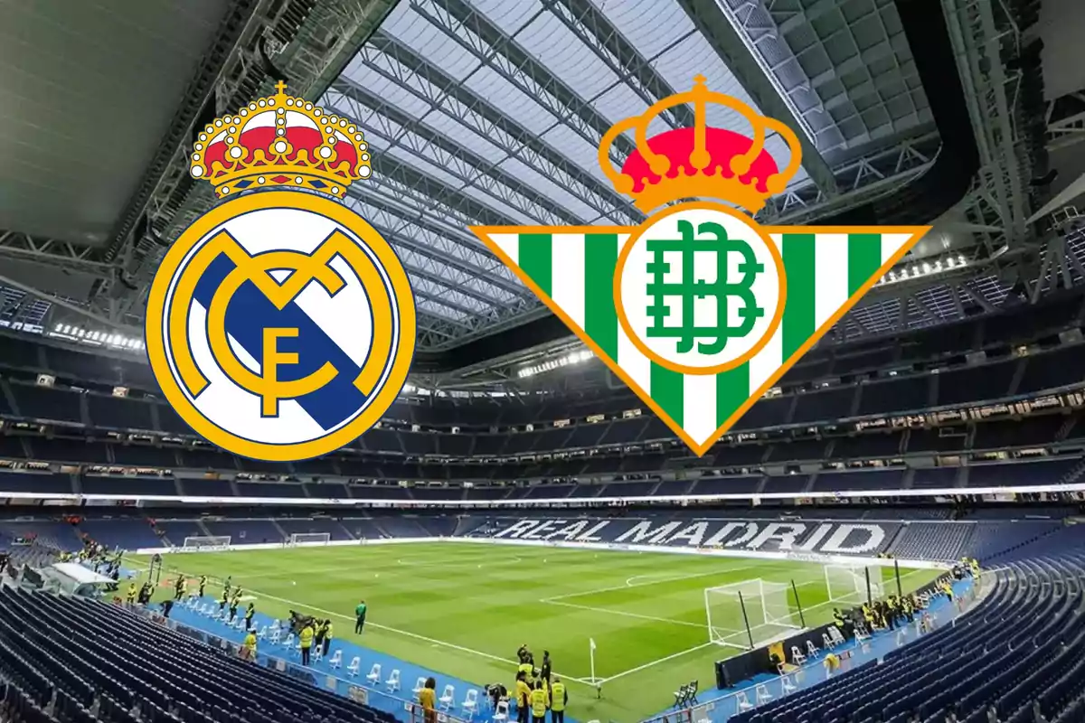 Logos de los equipos de fútbol Real Madrid y Real Betis sobre el fondo del estadio Santiago Bernabéu.