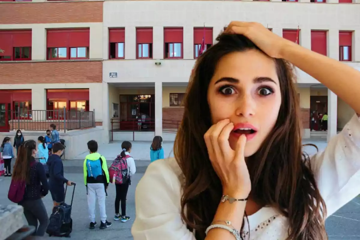 Una mujer con expresión de sorpresa está frente a un edificio escolar donde varios niños están reunidos en el patio.