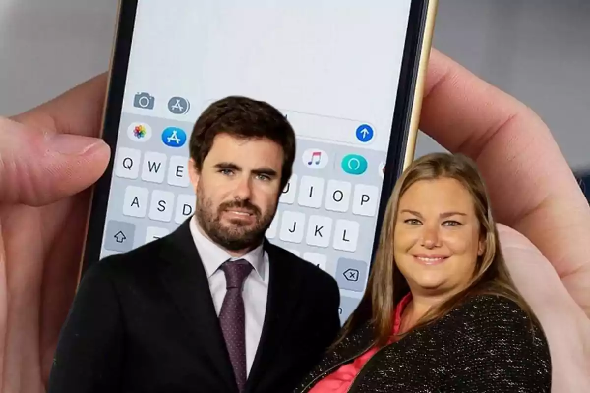 Dos personas posando frente a un teléfono móvil con la aplicación de mensajería abierta.