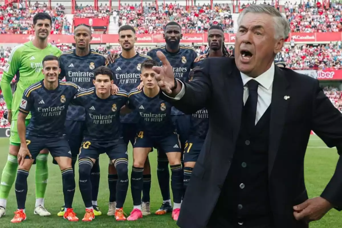 Un equipo de fútbol posando para una foto grupal en el campo, con su entrenador gesticulando en primer plano.