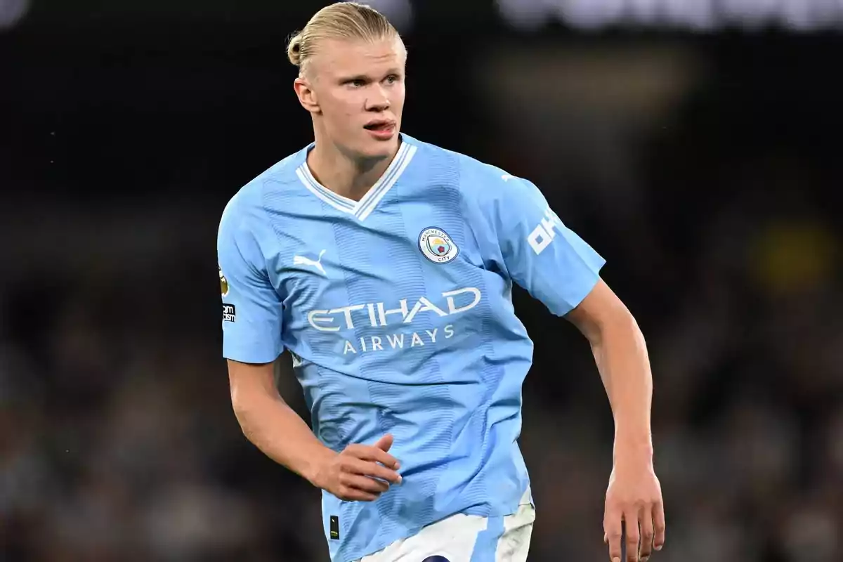 Jugador de fútbol con camiseta celeste del Manchester City en el campo de juego.