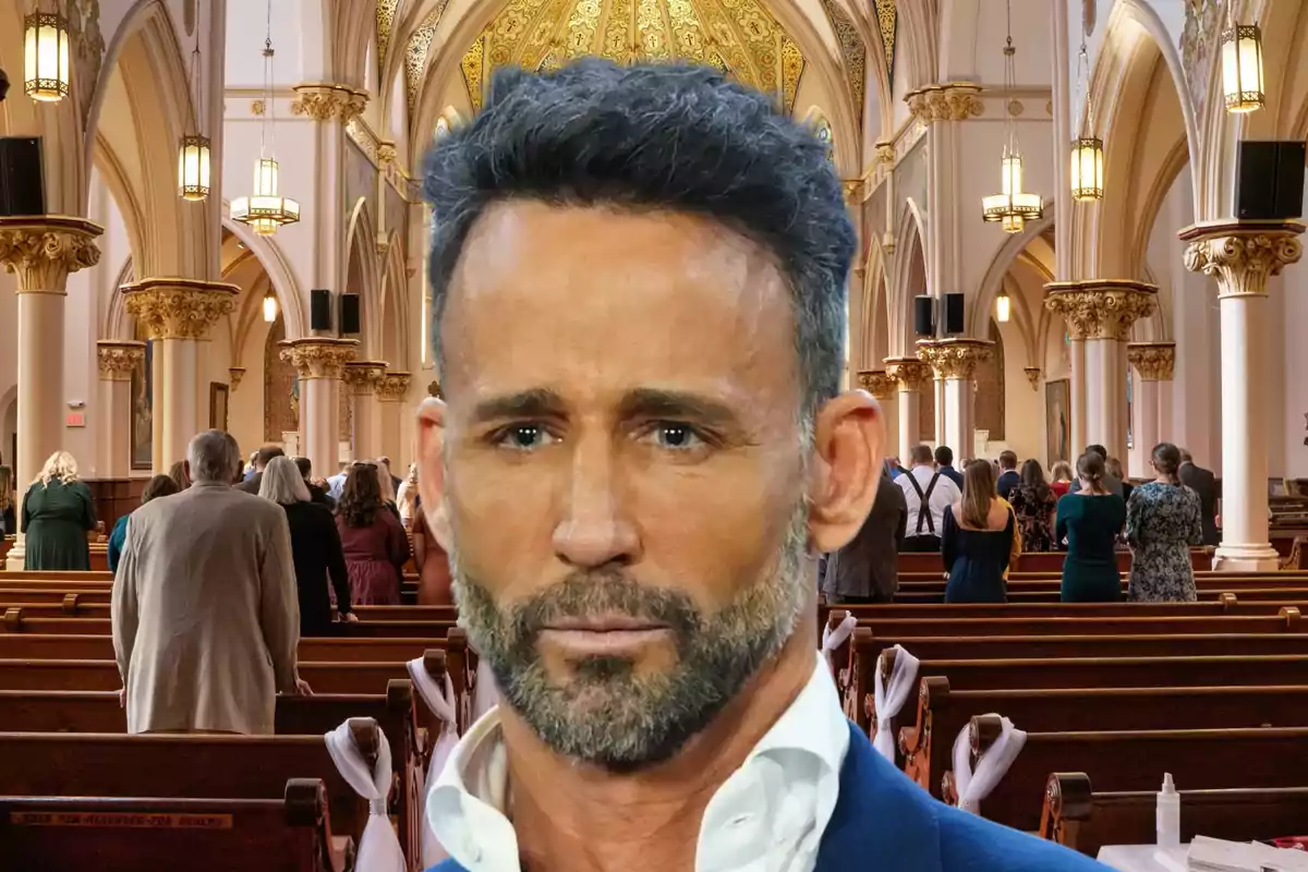 Un hombre con barba y cabello oscuro está en primer plano, con una iglesia llena de personas al fondo.