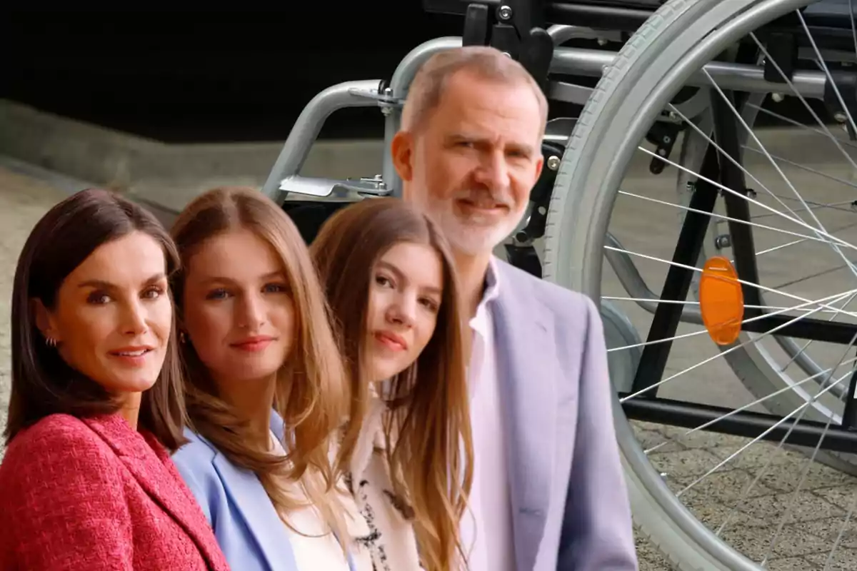 Una familia posando frente a una silla de ruedas.