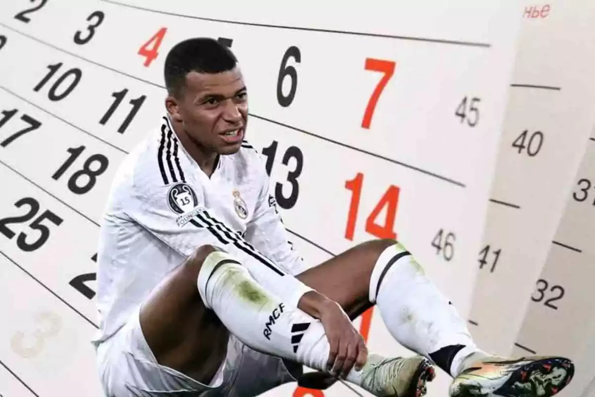 Un futbolista con uniforme blanco sentado frente a un calendario gigante.