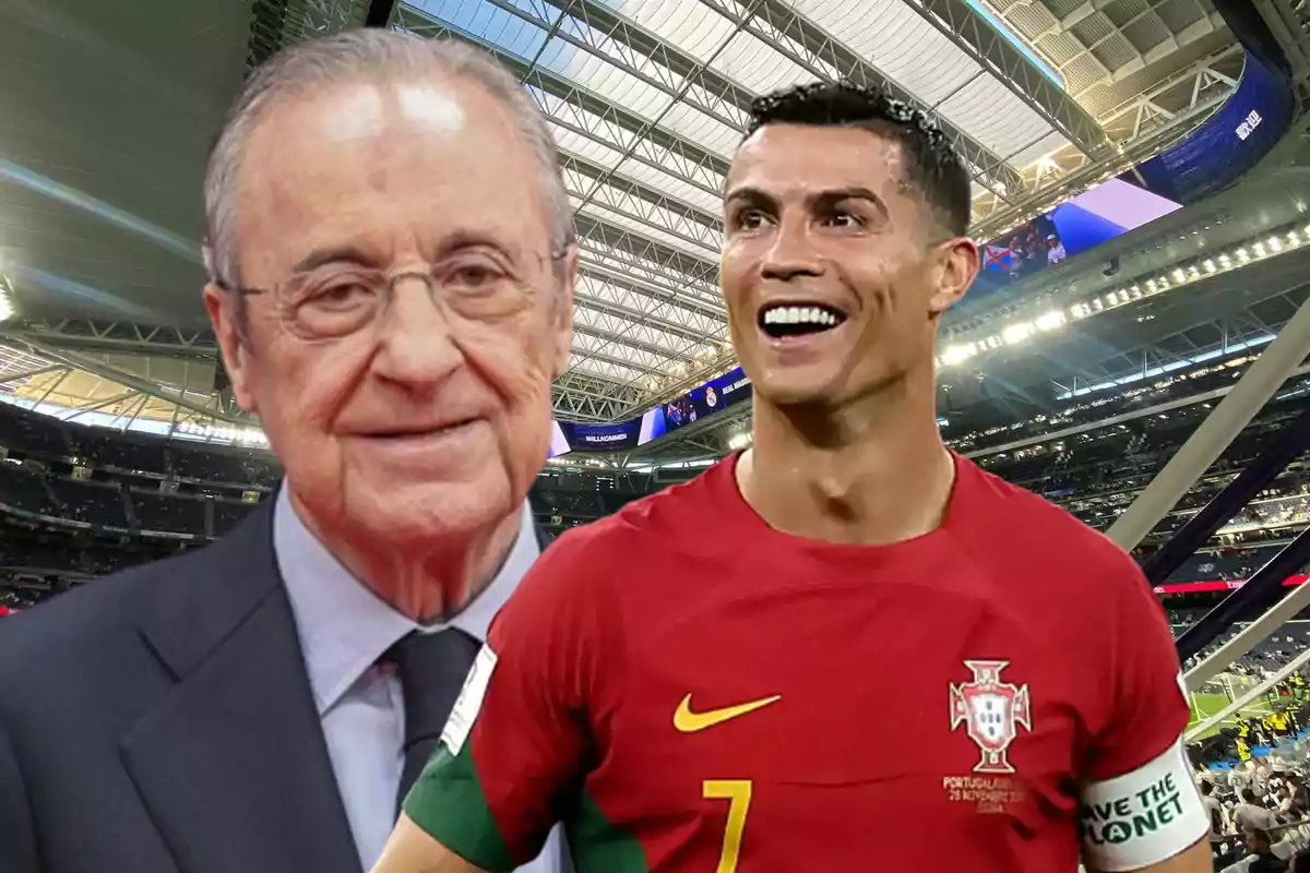 Dos hombres, uno mayor con gafas y traje, y otro más joven con uniforme de fútbol rojo, en un estadio cubierto.