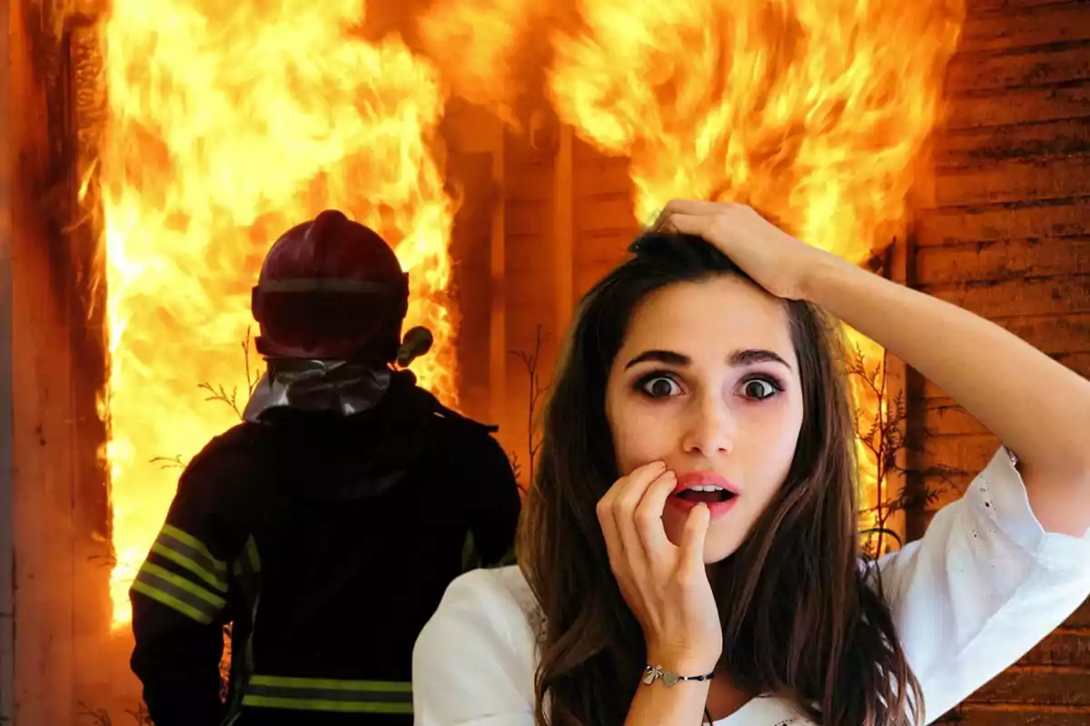 Una mujer con expresión de sorpresa y preocupación frente a un incendio mientras un bombero trabaja en el fondo.