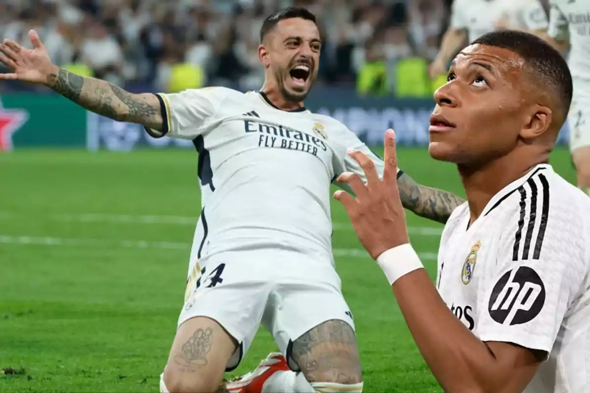 Dos jugadores de fútbol del Real Madrid celebran en el campo durante un partido.