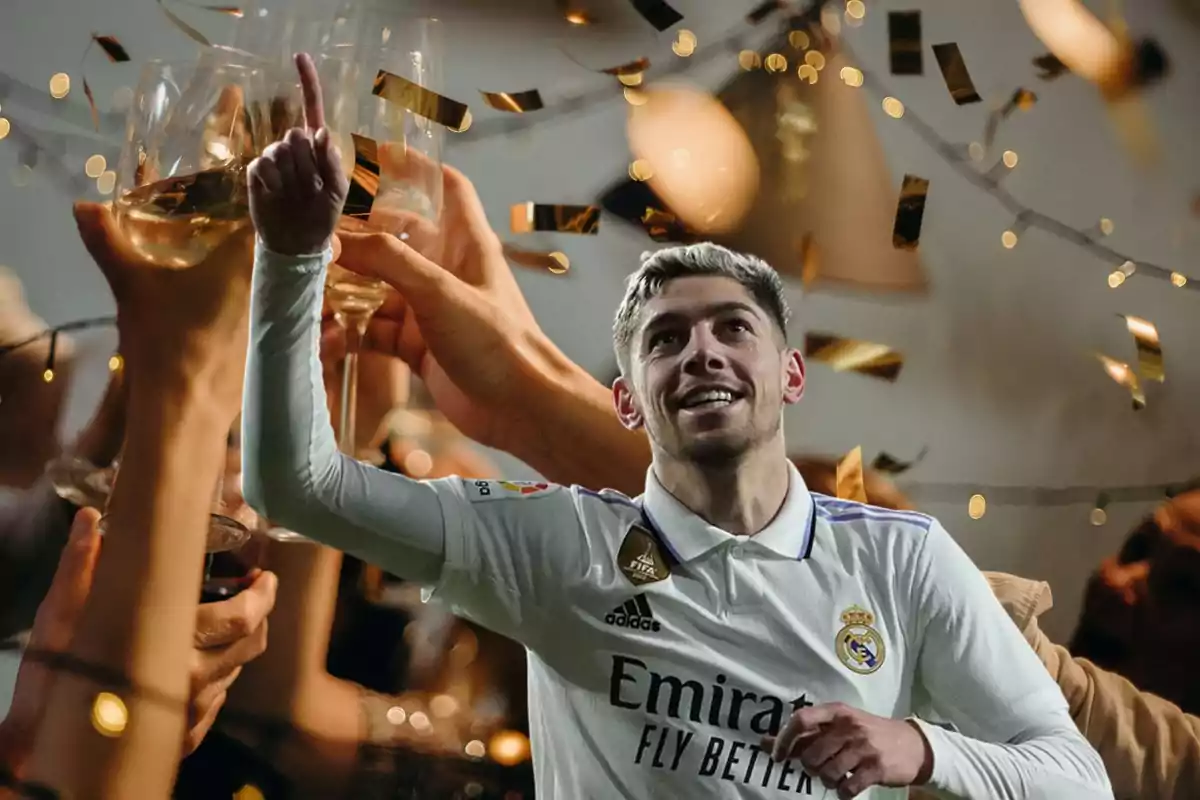 Un jugador de fútbol con la camiseta del Real Madrid celebra levantando el dedo índice mientras varias personas brindan con copas de vino y confeti dorado cae alrededor.