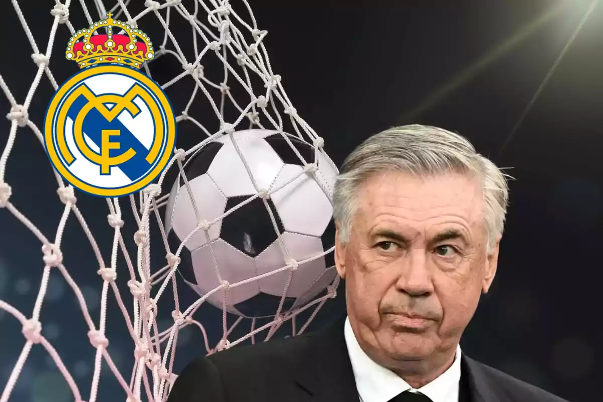 Un hombre de cabello canoso y traje oscuro frente a una red de fútbol con un balón y el escudo del Real Madrid.