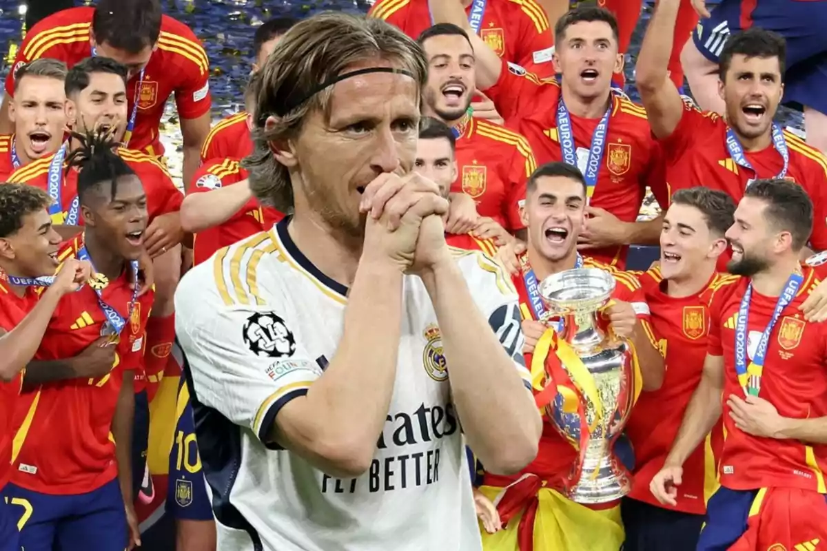 Un jugador de fútbol con la camiseta del Real Madrid aparece en primer plano, mientras que en el fondo se ve a un grupo de jugadores de la selección española celebrando con un trofeo.