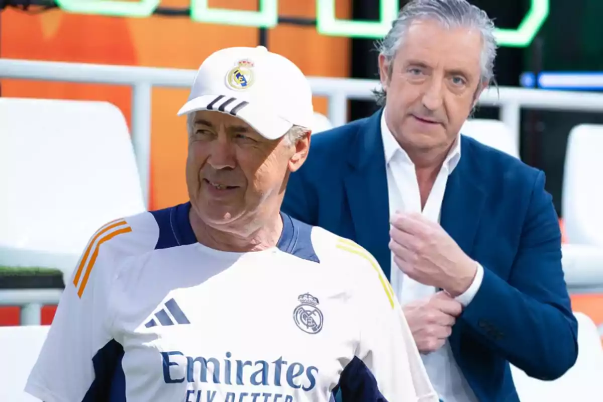 Dos hombres, uno con uniforme deportivo del Real Madrid y otro con traje azul, en un entorno deportivo.