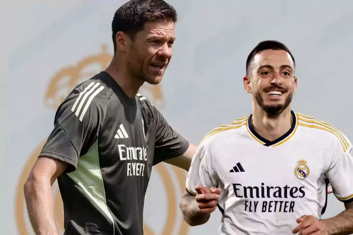 Dos hombres con uniforme del Real Madrid uno con camiseta de entrenamiento oscura y otro con camiseta de juego blanca ambos sonríen y están frente a un fondo claro con el escudo del club desenfocado