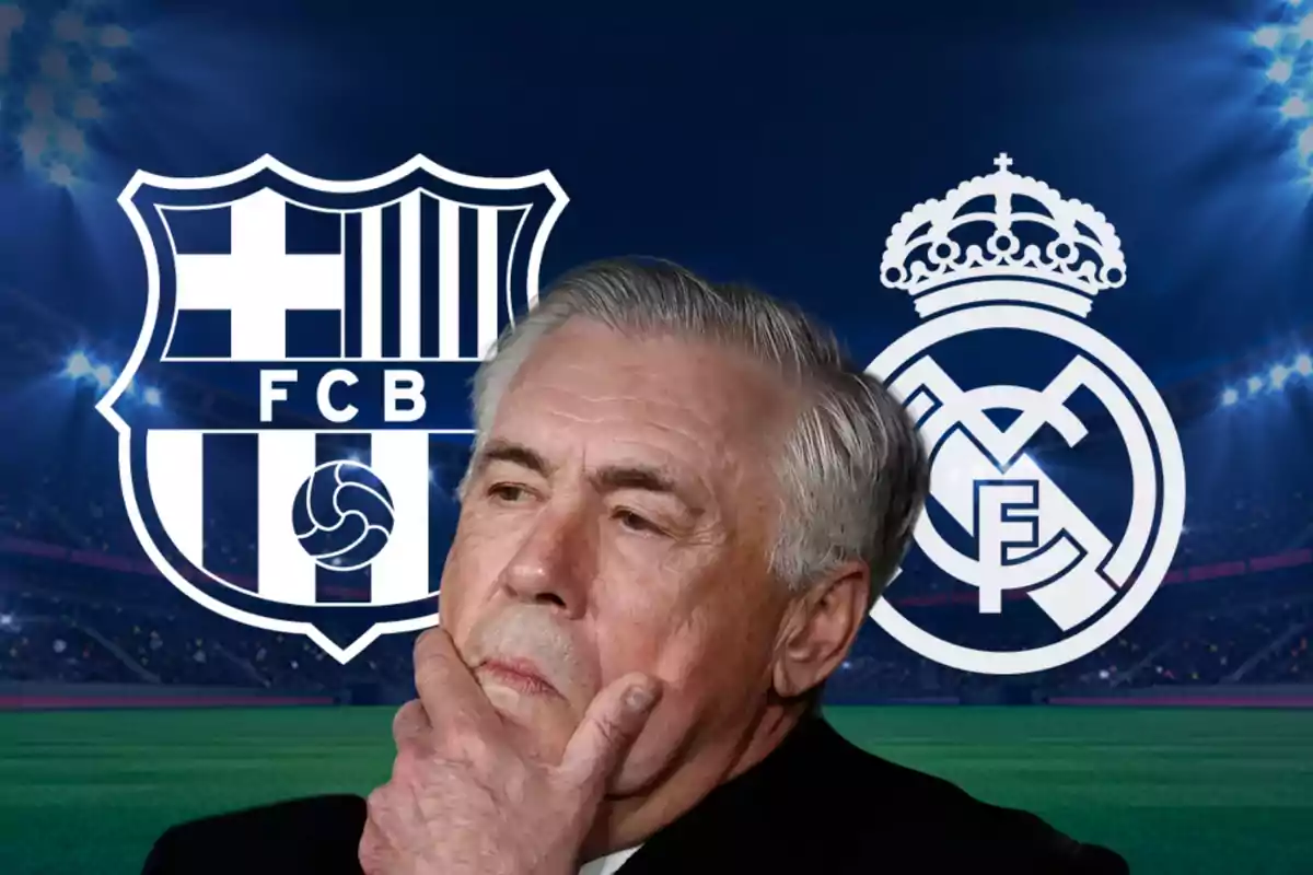 Un hombre pensativo con la mano en el mentón frente a los escudos de dos equipos de fútbol en un estadio iluminado.