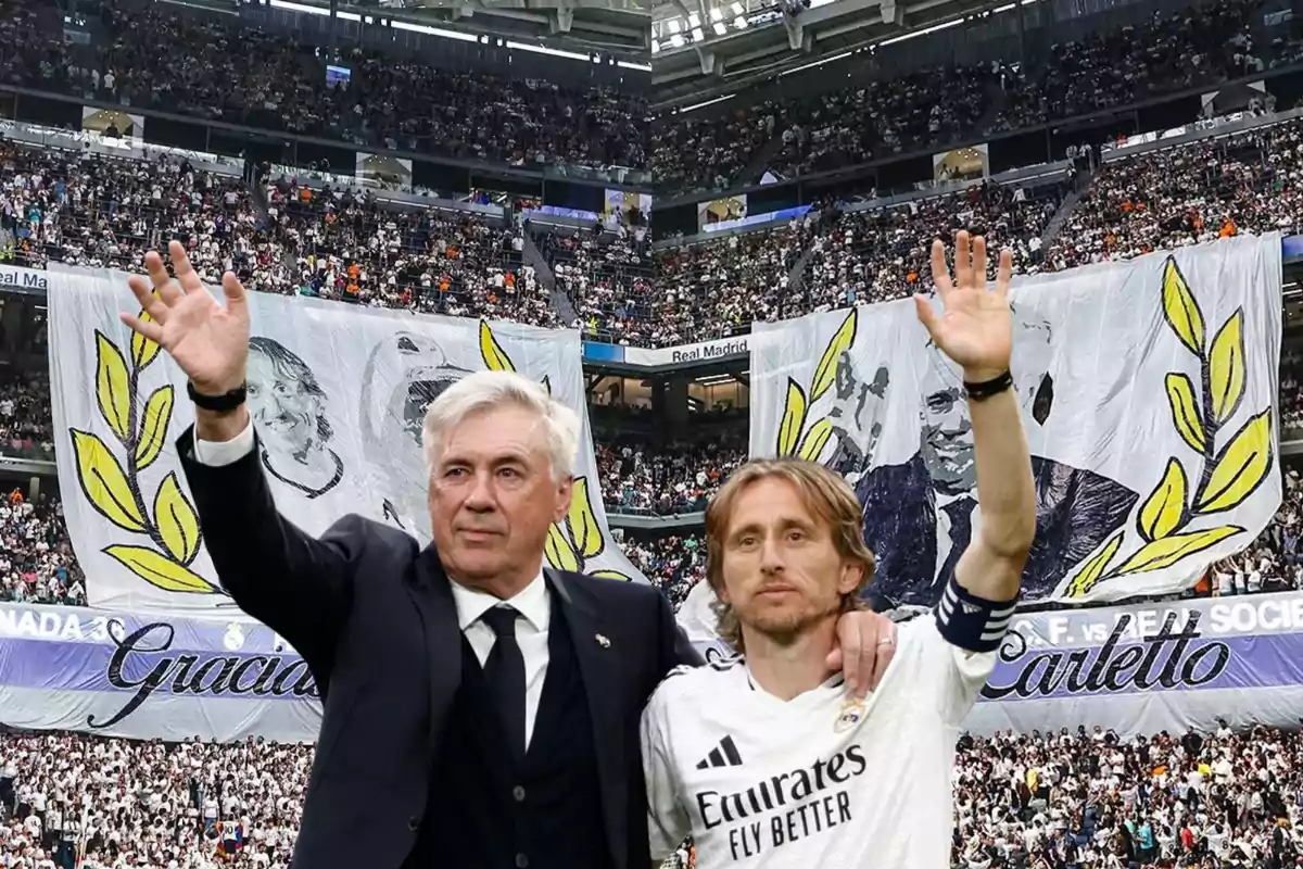 Dos personas en un estadio de fútbol saludan a la multitud, con una gran pancarta de fondo que muestra imágenes y texto de agradecimiento.