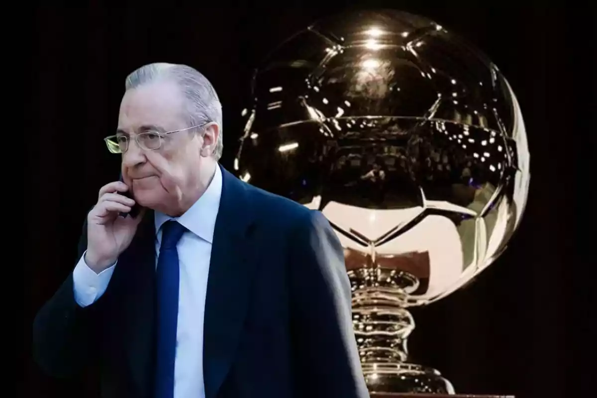 Hombre de traje hablando por teléfono con un trofeo dorado de fondo