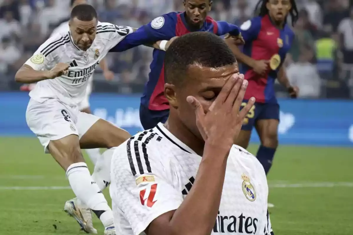 Un jugador de fútbol del Real Madrid se cubre el rostro con la mano mientras otros jugadores están en acción en el campo.