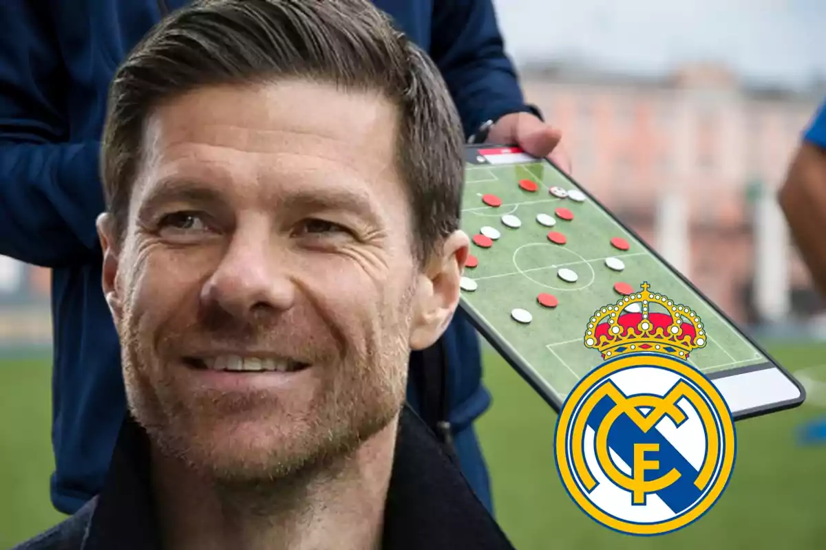 Hombre sonriente en primer plano con una pizarra táctica de fútbol y el escudo del Real Madrid al fondo