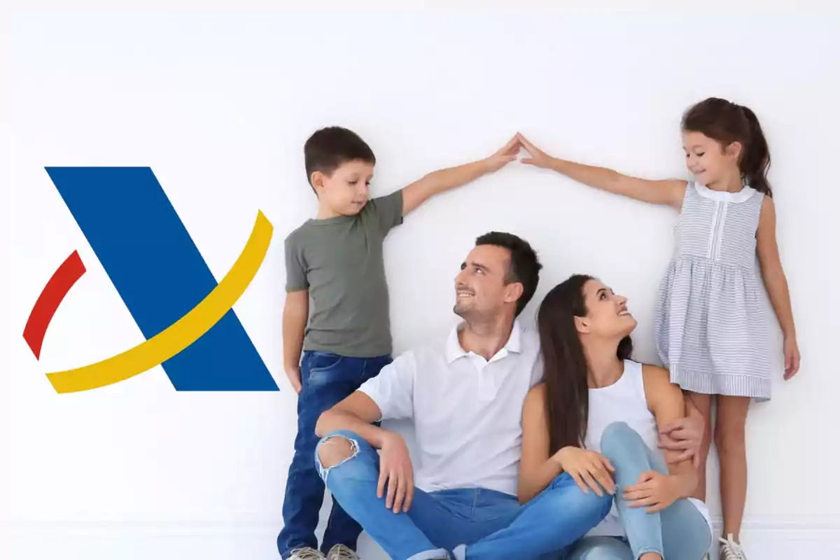 Una familia de cuatro personas, dos adultos y dos niños, sentados y sonriendo frente a una pared blanca con el logotipo de la Agencia Tributaria de España a la izquierda.