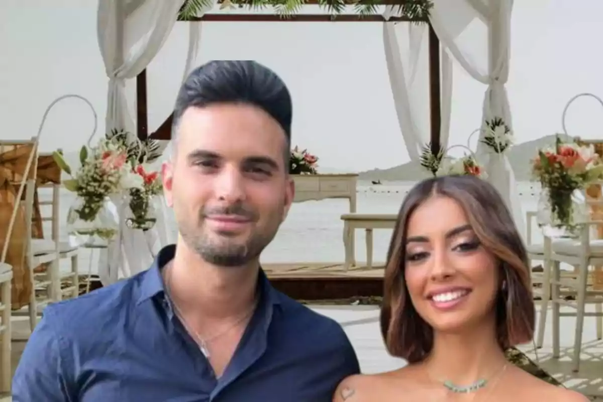 Una pareja sonriente posando frente a un altar decorado para una boda al aire libre.