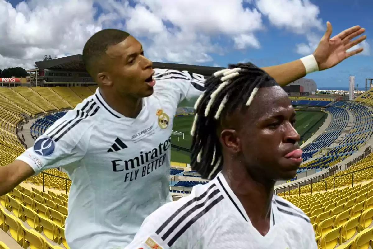 Dos jugadores de fútbol con la camiseta del Real Madrid celebran en un estadio vacío.