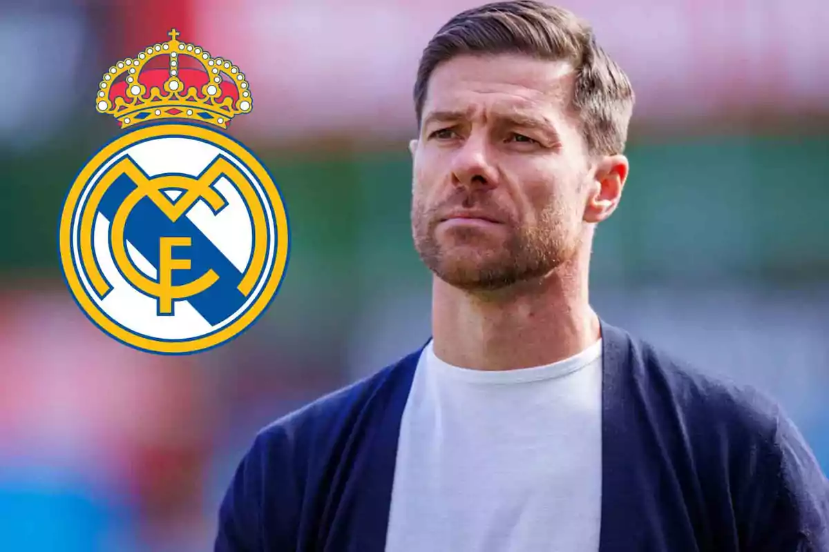 Hombre con barba y cabello corto junto al escudo del Real Madrid.